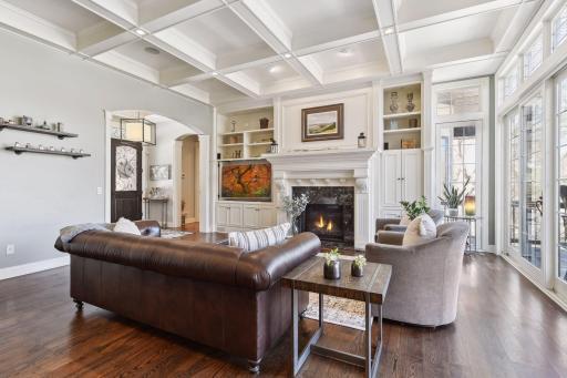 Beautiful, enameled fireplace mantle with decorative wood corbels flanking quartz gas fireplace. An abundance of recessed lighting and surround sound through entire home.