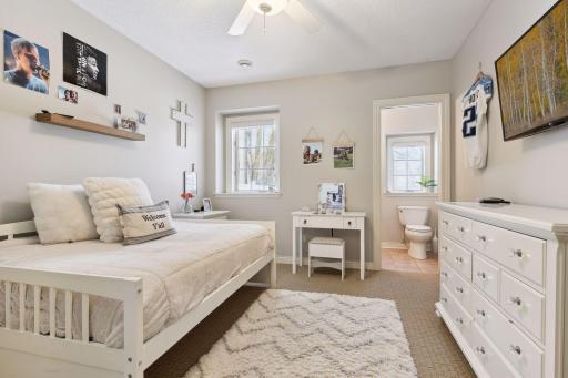 Second bedroom with walk-in closet, private bathroom, and walk-through shower.