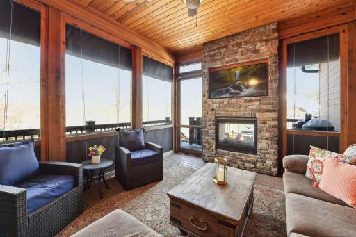 Gorgeous screen porch with dual-sided stone fireplace. Plastic window coverings roll down to allow use for all weather.