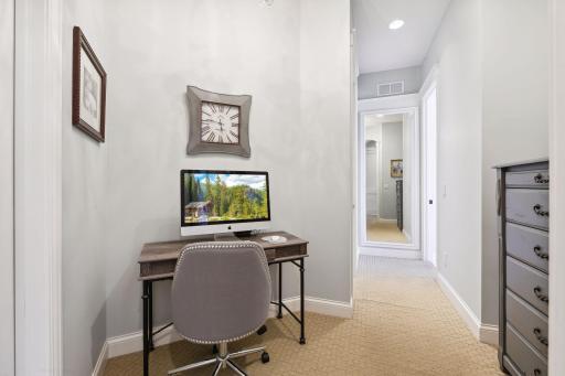 Primary wing with double doors leading to the primary bedroom, dual closets, work area, and hallway leading to the stunning primary bath.