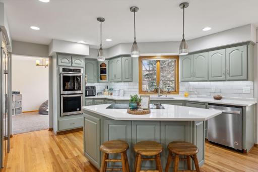 This gorgeous kitchen has been updated w/Quartz C-Tops, backsplash and painted cabinets.