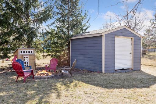 Convenient storage shed and a fire pit area.