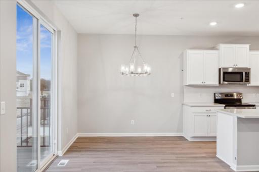 Dining area with sliding doors to balcony. Similar floorplan but different finishes.