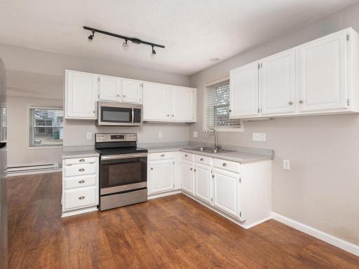 The kitchen offers stainless steel appliances and gorgeous updated flooring!