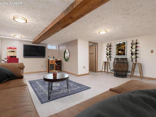 There's more space to enjoy in the lower level family room! Virtually staged.