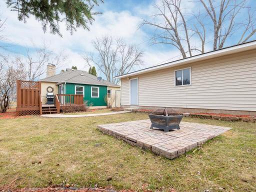 The backyard offers plenty of space and includes a firepit area and incredible double garage!