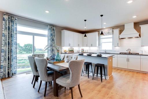 One of two dining spaces on the main level. This informal dining featured here provides ample space for entertaining family and friends. Photo of model; colors and selections may vary.