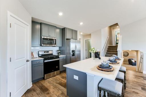 Stainless appliances, walk-in pantry, quartz counters, and subway backsplash! Photos of model home. Colors and options may vary. Ask Sales Agent for details.