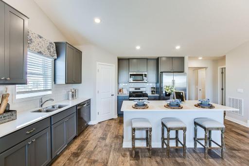 The smart layout in the Finnegan kitchen also features a window above the kitchen sink. Photos of model home. Colors and options may vary. Ask Sales Agent for details.