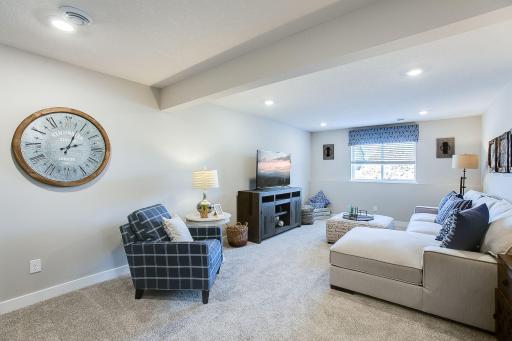 The lower level included finishes features a sizeable rec room, fourth bedroom, and third bathroom. Photos of model home. Colors and options may vary. Ask Sales Agent for details.