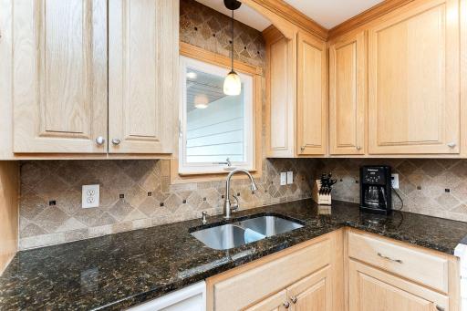 Granite counters and a window over the sink to lookout over the backyard!