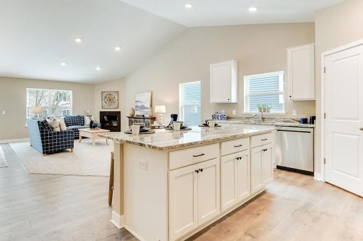 The expansive kitchen area transitions seamlessly into the open and spacious family room and dinette area. Soaring vaulted ceiling. Photos of model. Options and colors may vary.