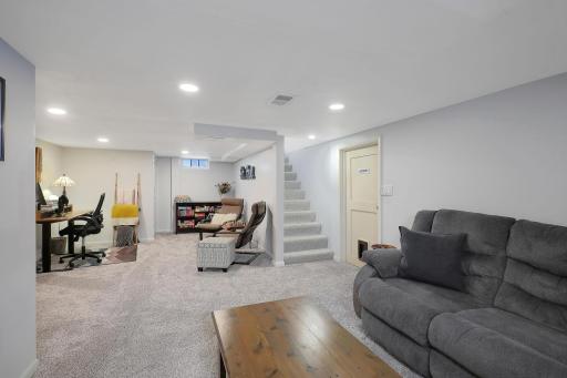 The lower level family room was modeled with new carpet and recessed lighting .