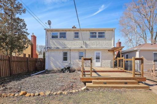 Beautiful back yard oasis with large deck, garden space and privacy fence.