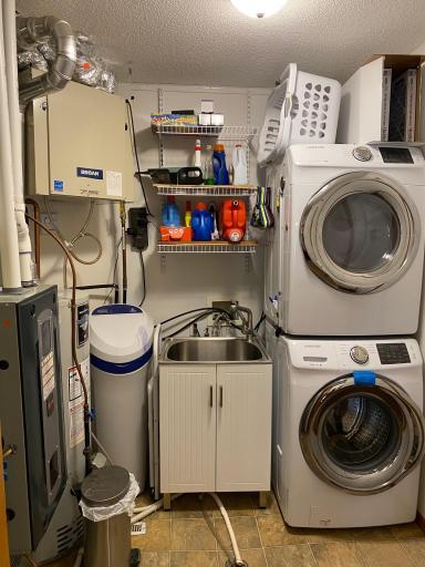 Photo for 2271 Highway 27 E, 8, Osakis, MN 56360 - Listing #6506633 Laundry, mechanicals, and large closet make up this efficient laundry room. Washer and dryer are stacked to make room for the utility sink.