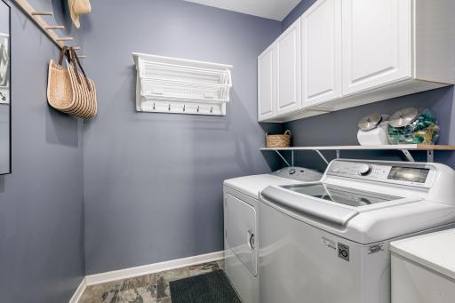 The main floor laundry area is near the mudroom, kitchen and garage entry area.