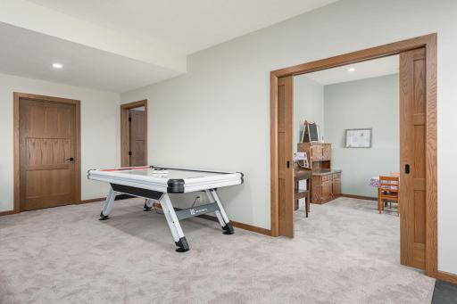 Enough room in the huge family room area for a pool table, ping pong table or an air hockey table as shown. The flex room in view has french doors to create a private area if desired.