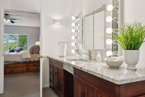 No reason to share a vanity here, this extraordinary primary bath features two separate vanities, one with make up vanity