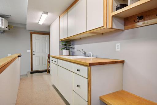 This great area was custom designed in the garage for ease of removing shoes or cleaning up prior to entering the home