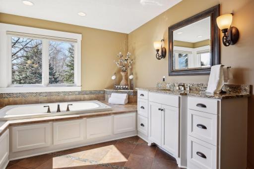 The primary bathroom has dual vanity areas