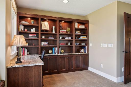 There is a convenient built in desk and shelving also within the upper level primary suite