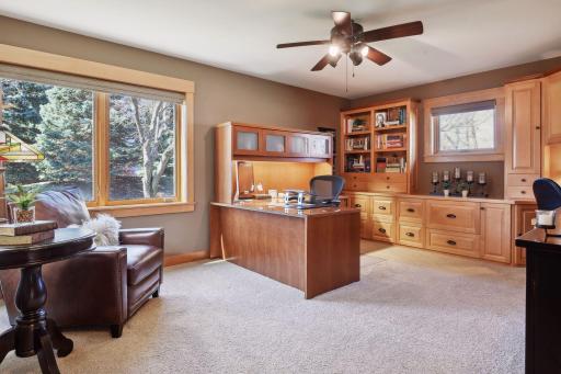 The original main floor primary suite has been used as an spacious office with built-in drawers and bookcases.