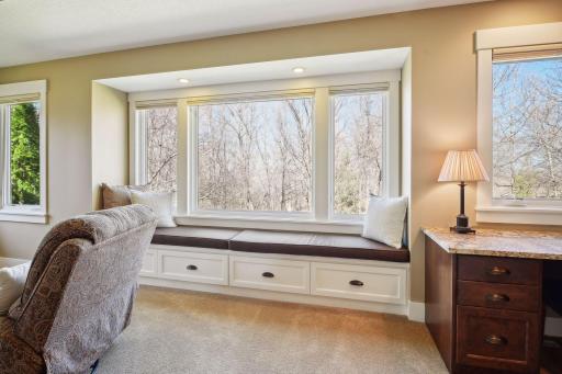 The primary sitting area overlooks the beautiful yard and lake