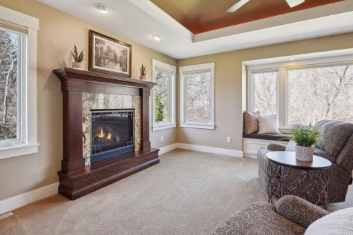 There is a cozy sitting area with a gas fireplace within the primary suite