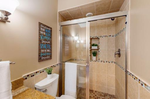 The upper level bedrooms share a lovely 3/4 bath with fully tiled shower with glass doors