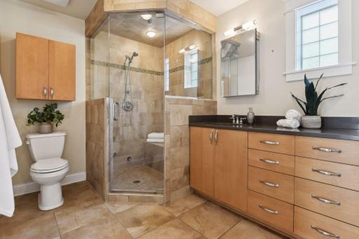 The en-suite bathroom is a spa-like retreat, boasting modern fixtures, elegant finishes, and a serene ambiance perfect for unwinding after a long day.