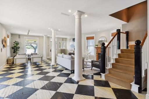 The contrast of the floors evokes a sense of drama and sophistication, while the geometric precision of the checkerboard motif adds a touch of whimsy and charm.