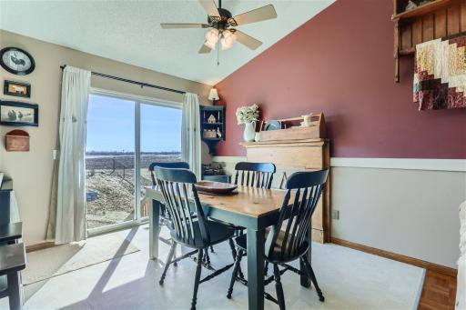 Separate dining space overlooking the fully fenced backyard and open farm land.