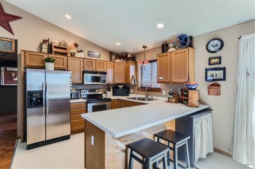 Open concept kitchen with stainless steel appliances.