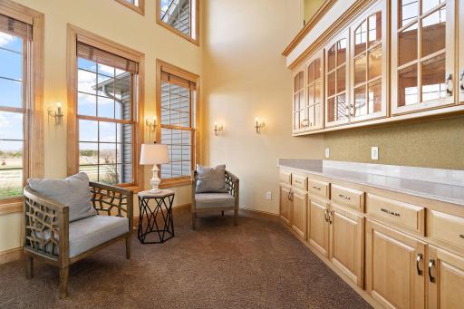 Adjacent to the foyer, discover a versatile open den adorned with built-in cabinetry, ideal for a cozy seating area or a productive home office space, with picturesque front yard views.