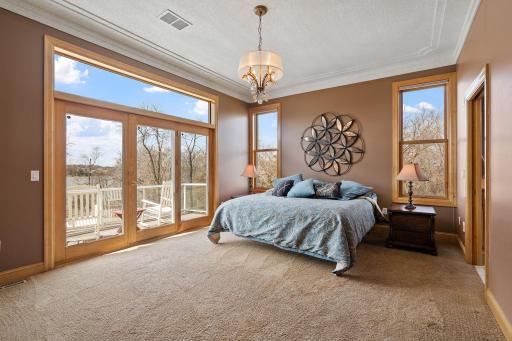 Retreat to the luxurious primary suite boasting a soaring 10-foot race track ceiling, remote-controlled shades, and private access to the back deck with serene lake views.
