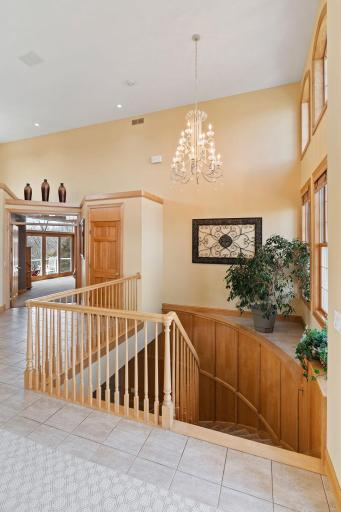 Spiral staircase under the charming chandelier leads you to the walk-out lower level.
