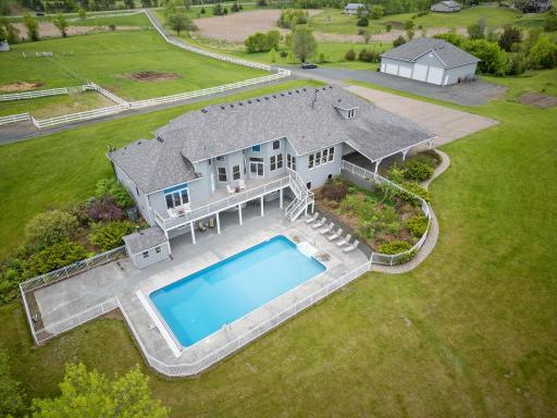 A fenced-in heated pool surrounded by stamped concrete patio, and a pool shed for all your storage needs, creating the ultimate outdoor oasis for relaxation and recreation.