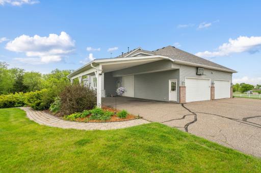 A separate garage door leads to a covered carport, offering additional covered parking options.