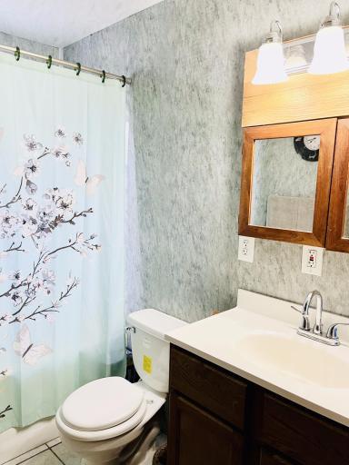 Main bathroom, laundry shoot behind 1/2 mirror, full tub and shower.jpg