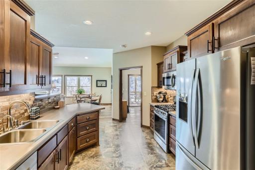 The kitchen boasts abundant cabinetry and stainless appliances.