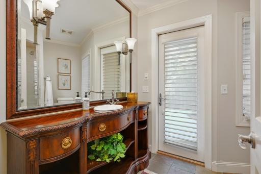 Main floor powder room leads to secret garden with Jacuzzi.