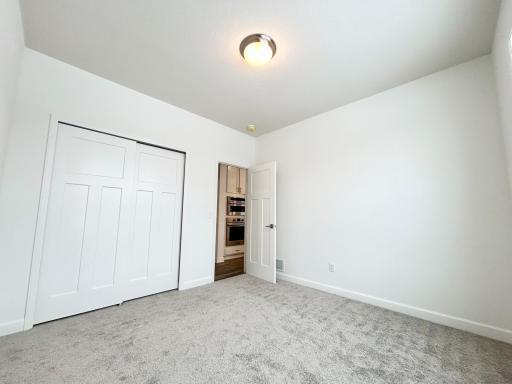 Main Floor Bedroom of a similar home and floor plan. Options, colors and features may vary.