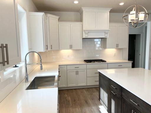 Designer PLUS gourmet kitchen stainless steel farmhouse sink and tile backsplash.