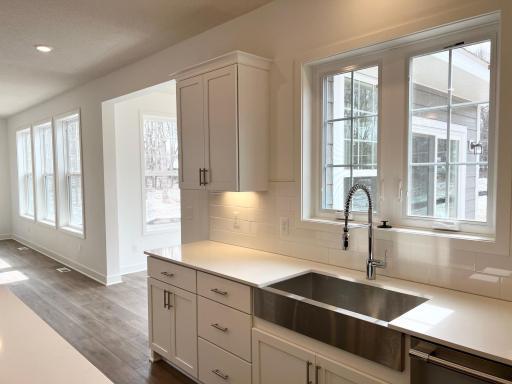 Designer PLUS farmhouse kitchen sink and walls of windows!
