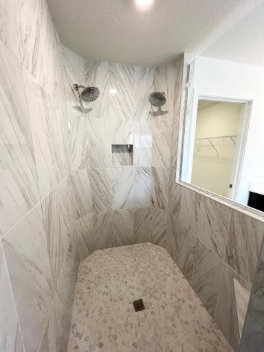 Walk in tiled serenity shower in primary suite. Two shower heads!