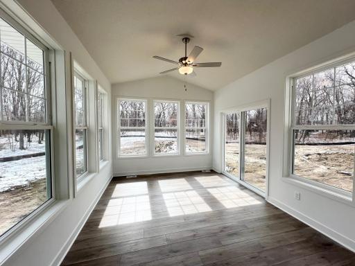 Four season porch with vaulted ceiling and ceiling fan. Gorgeous views!