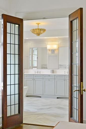 French Doors lead into the Luxurious Primary Suite Bath with Beautiful Tile and Heated Floors.