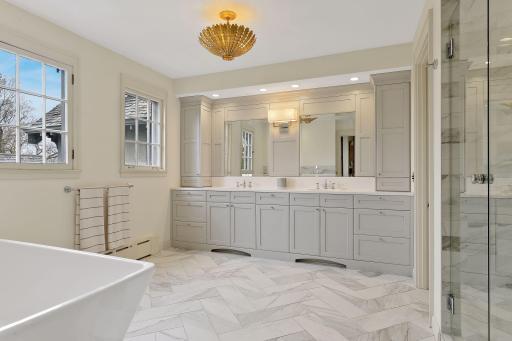 All the Special Features of a Custom Primary Bath: Heated Floors, a Large Soaking Tub, Spacious Walk-in Steam Shower, Water Closet, and Beautiful Cabinetry. Windows to the West overlook the Backyard.