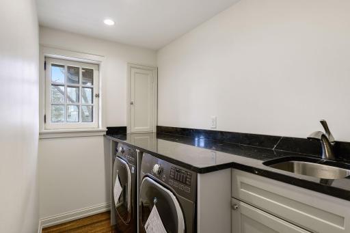 Upper Level Laundry Room with Sink and Storage.