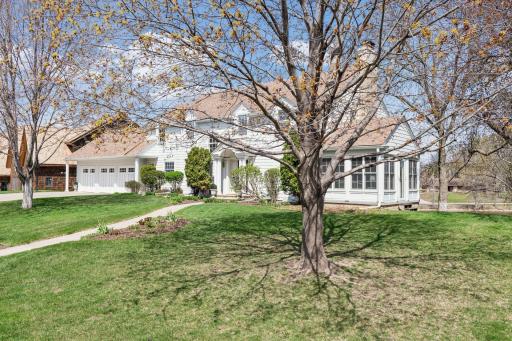Two story with curb appeal! Sun room on side with 3 walls of windows.